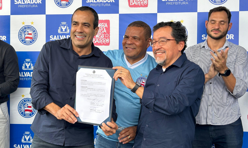 Prefeito Bruno Reis e o CEO do Bahia, Raul Aguirre, assinando o termo de cessão do campo Arena da Rocinha para o Bahia SAF